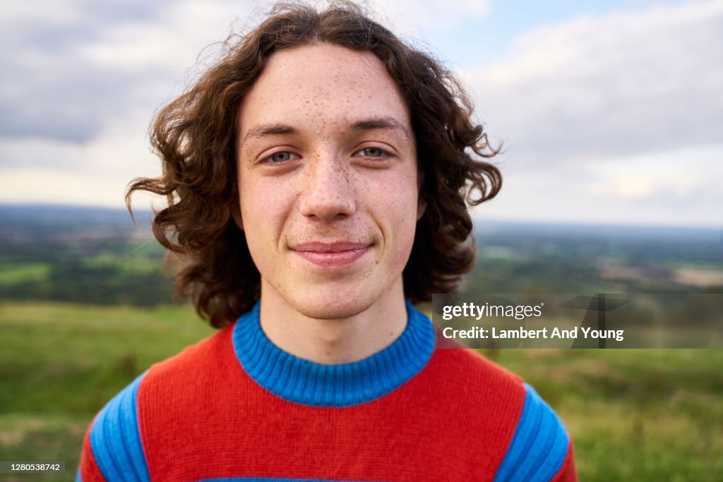 Close up portrait of a teenager looking to the camera in the outdoors