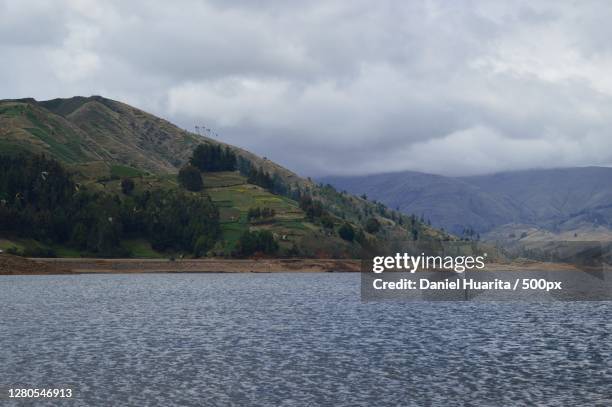 scenic view of lake by mountains against sky,chapare,cochabamba,bolivia - cochabamba stock-fotos und bilder