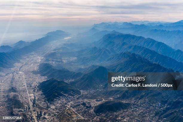 aerial view of snowcapped mountains against sky,monterrey,mexico - monterrey mexico photos et images de collection