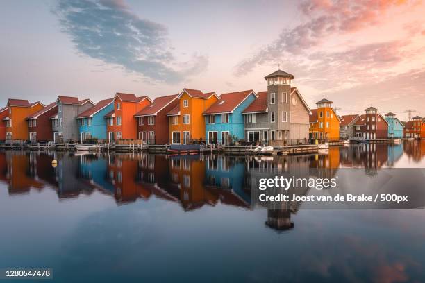 scenic view of lake by buildings against sky,groningen,netherlands - província de groningen imagens e fotografias de stock
