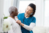 Female home healthcare providers checks patient's vital signs