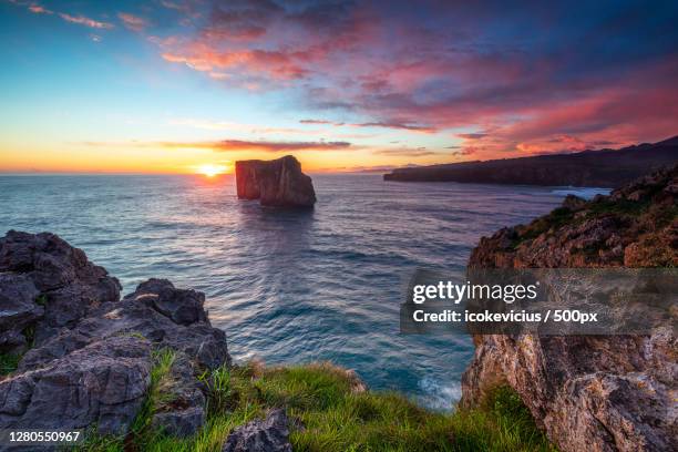 scenic view of sea against sky during sunset - llanes stock-fotos und bilder