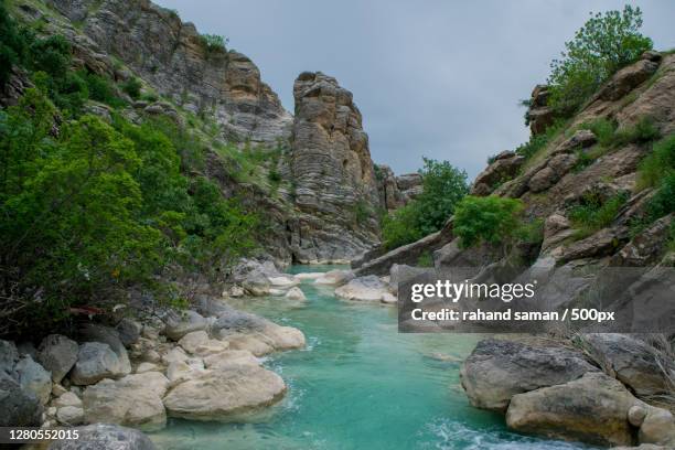 scenic view of rocks by sea against sky,dokan,iraq - iraq landscape stock pictures, royalty-free photos & images