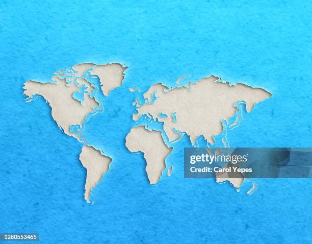 world map with paper cut effect on blue background - europa kontinent stock-fotos und bilder