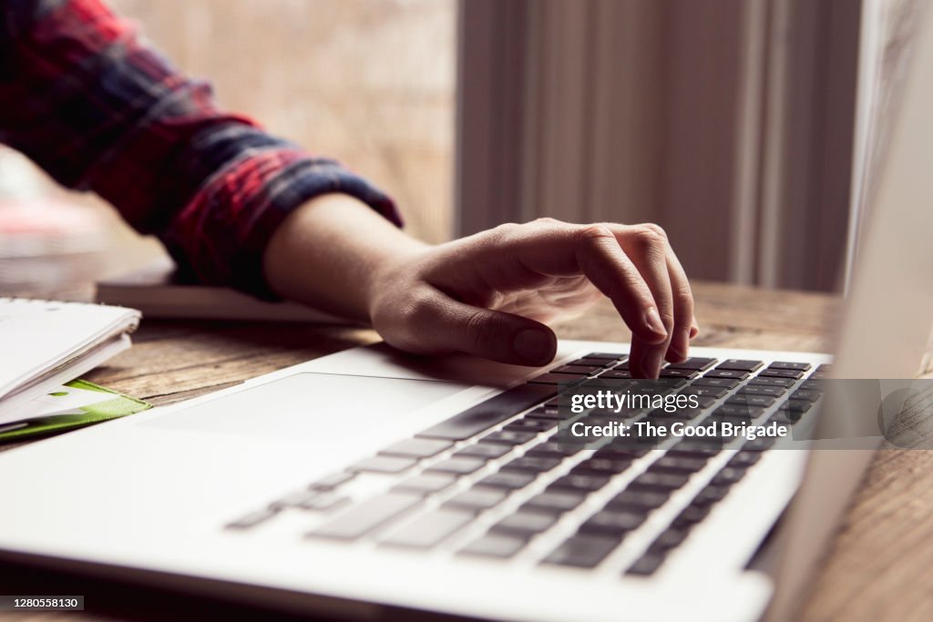 Close up teenage girl using laptop computer