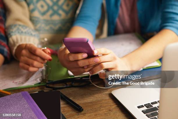 close up teenage hands with laptop and smart phone - digital native stock-fotos und bilder