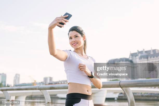 woman taking selfies during fitness session - argentina training session stock pictures, royalty-free photos & images