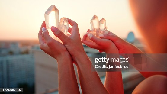 Sisters meditating with healing crystals. Rooftop view Sisters meditating with healing crystals. Rooftop view