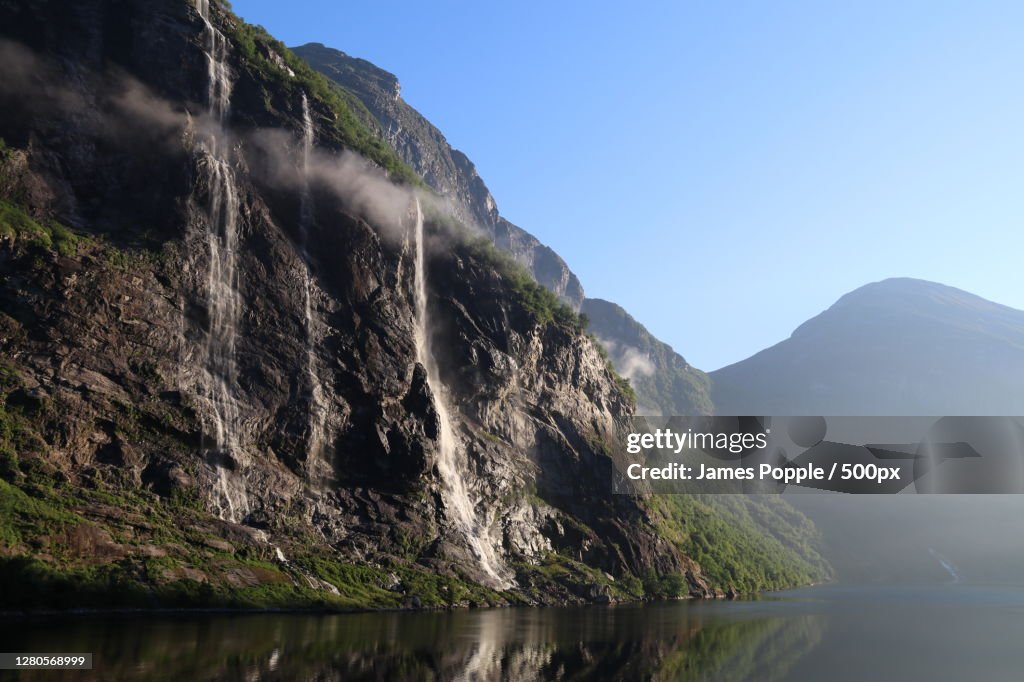 Scenic view of lake and mountains against clear sky, Geiranger, Norway