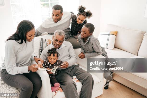 happy family with grandkids and grandfather at home during winter holidays - happy holidays family stock pictures, royalty-free photos & images