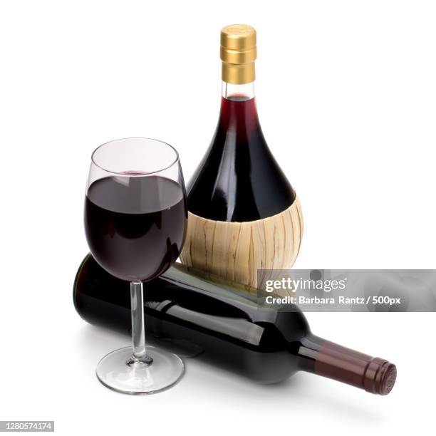 close-up of wine bottles and wine bottle against white background - barbara tag fotografías e imágenes de stock