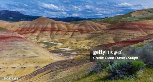 scenic view of landscape against cloudy sky,painted hills,oregon,united states,usa - oregon stock pictures, royalty-free photos & images