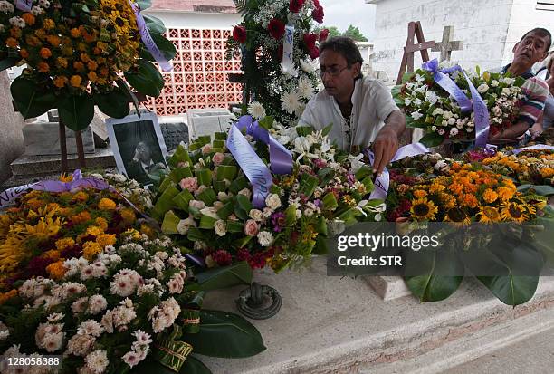 Wreathes of flowers are placed in the tomb of Cuban musician Ignacio Villas, known as Bola de Nieve, on October 5, 2011 in Havana. Dozens of Cubans...