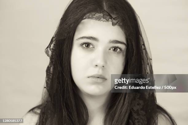 portrait of young woman against white background,plasencia,extremadura,spain - luto ストックフォトと画像