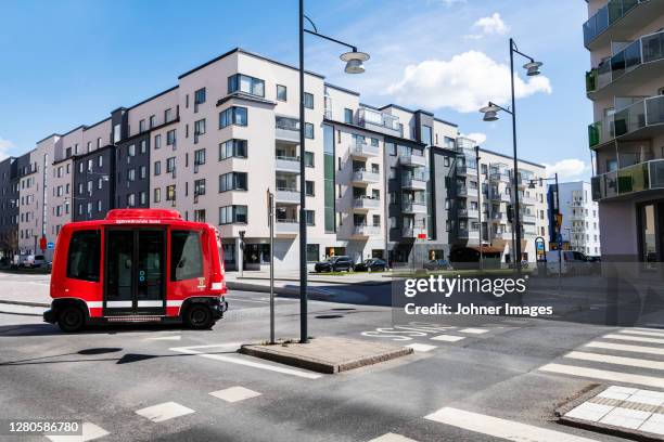 bus on road, blocks of flats on background - autonomous driving stock pictures, royalty-free photos & images