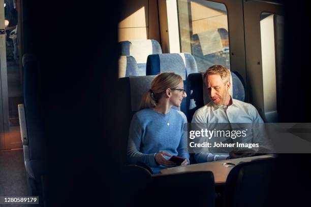 couple in train carriage - couple in a train stock pictures, royalty-free photos & images