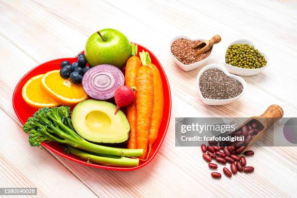 fruits, vegetables and seeds on white table - broccoli white background stock pictures, royalty-free photos & images