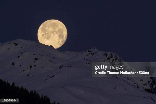 low angle view of snowcapped mountains against sky at night, mayrhofen, austria - beautiful moon stock pictures, royalty-free photos & images