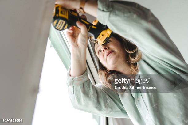 woman using electric drill - johner images bildbanksfoton och bilder