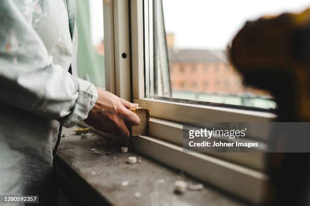 womans hand sanding window frame - sandpapper bildbanksfoton och bilder