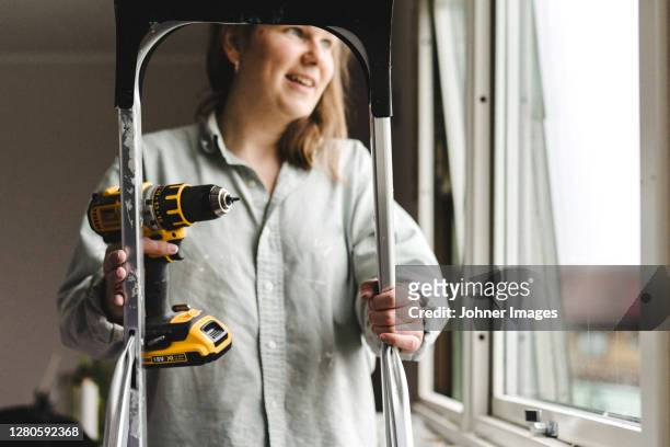 woman holding electric drill - johner images bildbanksfoton och bilder