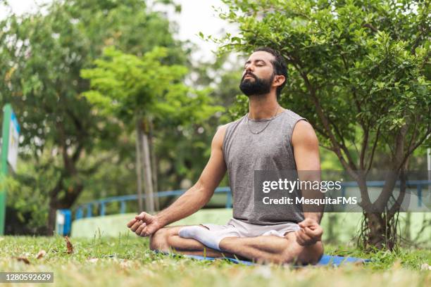 mann meditiert im freien - atemübung yoga 30 bis 40 jahre stock-fotos und bilder