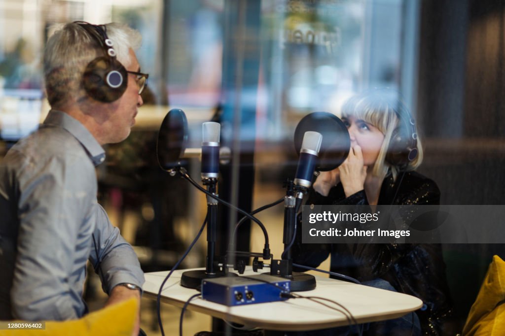 People broadcasting from radio station