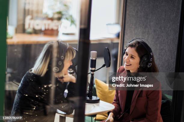 woman broadcasting from radio station - reporter microphone stock pictures, royalty-free photos & images