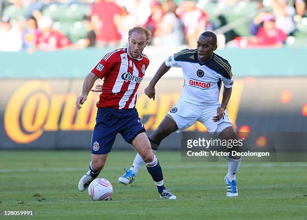 Simon Elliott of Chivas USA controls the ball under pressure from Amobi Okugo of the Philadelphia Union during the MLS match at The Home Depot Center...