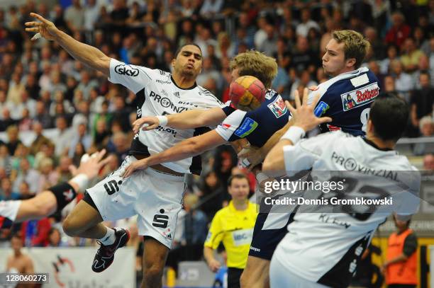 Daniel Narcisse of Kiel passes the ball to team mate Dominik Klein during the Toyota Handball Bundesliga match between HBW Balingen-Weilstetten and...