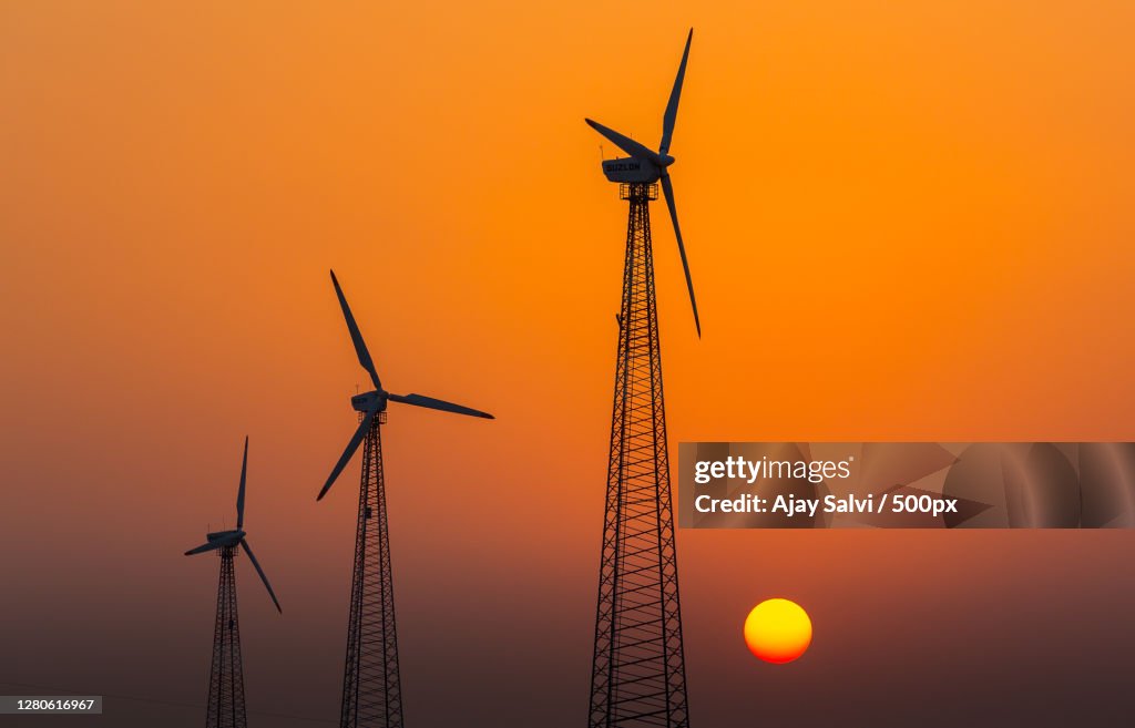 Low angle view of silhouette of windmills against sky during sunset,Jodhpur,Rajasthan,India