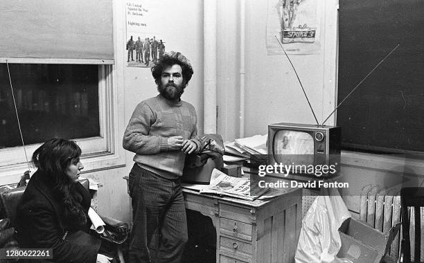 American political and social activist, and a member of the Chicago Seven, Jerry Rubin watches televised evening news coverage of the group's trial...