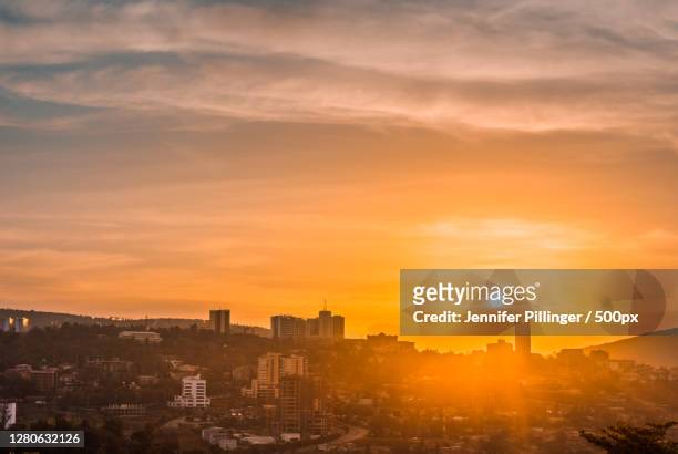 high angle view of buildings against sky during sunset,kigali,rwanda - kigali photos et images de collection