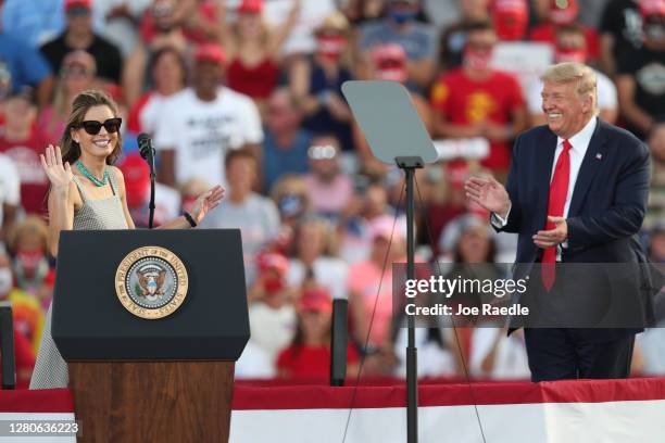 President Donald Trump laughs as Hope Hicks, a senior adviser to the president, speaks to the crowd after the president brought her on stage during a...