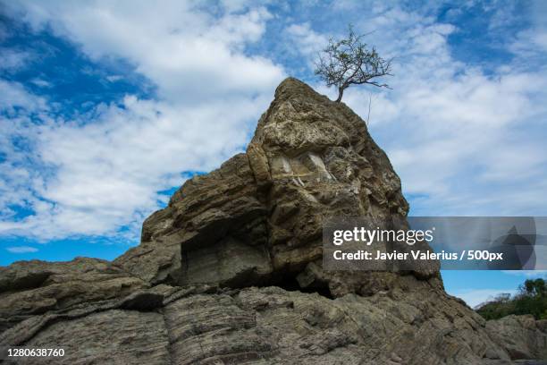 low angle view of rock formation against sky,playa carrillo,guanacaste province,costa rica - playa carrillo stock pictures, royalty-free photos & images