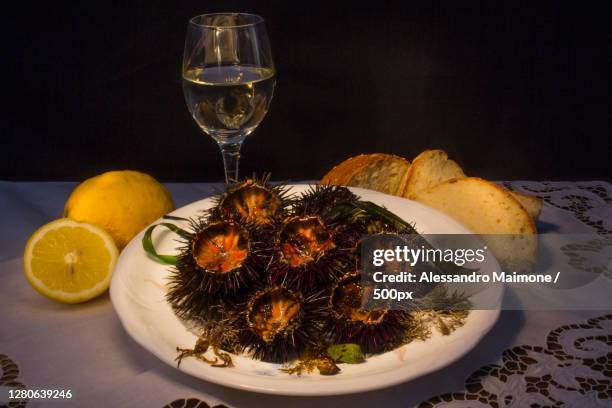 close-up of food and drink on table - sea urchin stockfoto's en -beelden
