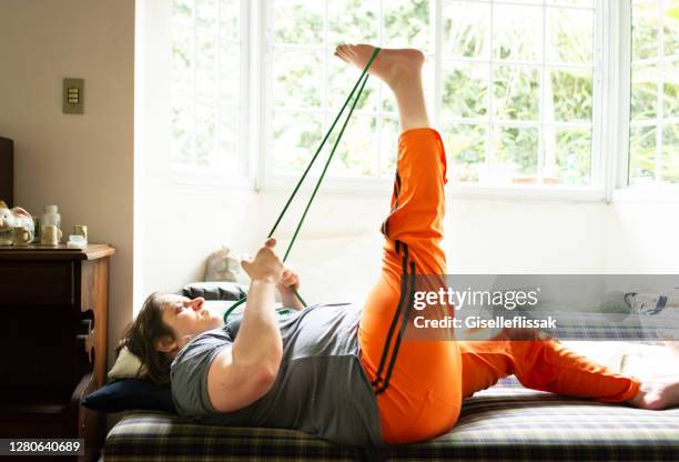 woman exercising at home - showus yoga stock pictures, royalty-free photos & images