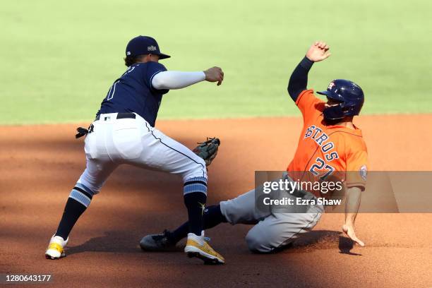 Jose Altuve of the Houston Astros is tagged out at second by Willy Adames of the Tampa Bay Rays on an attempted steal during the first inning in Game...