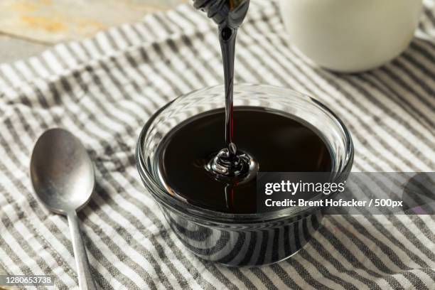 high angle view of wine pouring in glass on table - melaço imagens e fotografias de stock