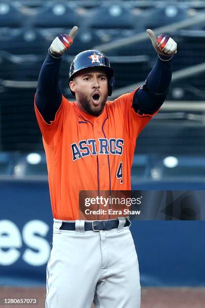 George Springer of the Houston Astros celebrates a two run single against the Tampa Bay Rays during the fifth inning in Game Six of the American...