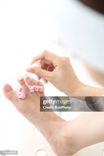 young woman painted in foot pedicure - japanese women feet stock pictures, royalty-free photos & images