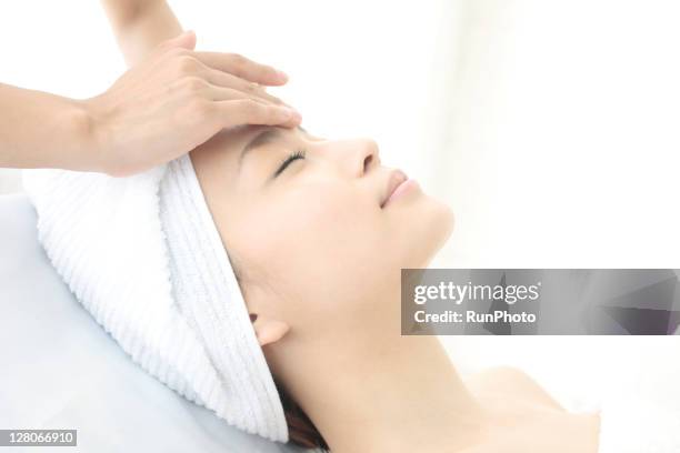 young woman receiving massage,woman in health spa - spa treatment stock pictures, royalty-free photos & images