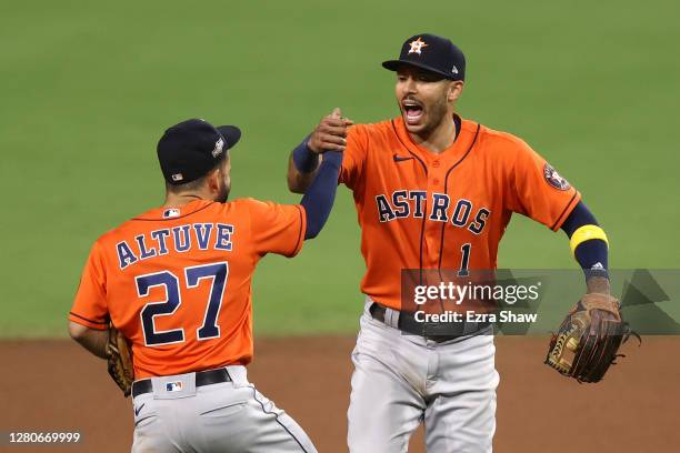 Jose Altuve and Carlos Correa of the Houston Astros celebrate a 7-4 win against the Tampa Bay Rays in Game Six of the American League Championship...