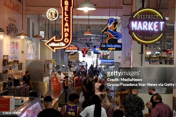 People wearing masks due to the Coronavirus Pandemic visit the Grand Central Market in Los Angeles on Friday, October 16, 2020.