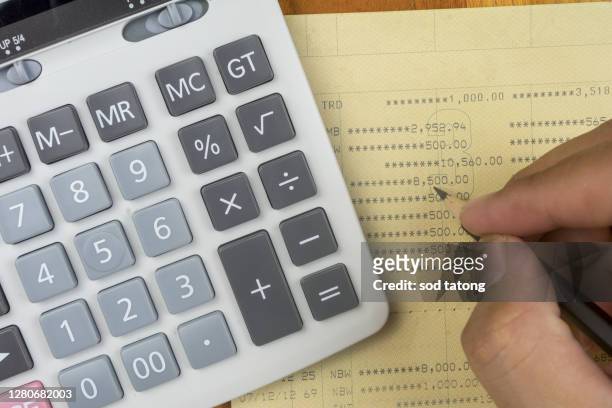 close up top view of calculator,book bank and pencil for counting and planning about monthly expenses at home for retirement lifestyle concept - bank statement stock-fotos und bilder