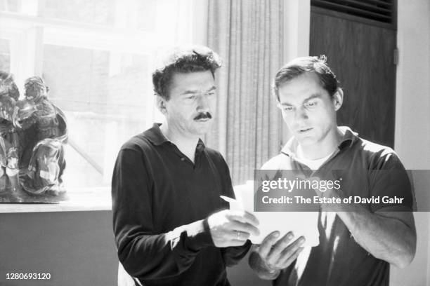 French author and filmmaker Alain Robbe-Grillet and Groce Press editor Richard Seaver confer on a manuscript in September, 1964 in New York City, New...