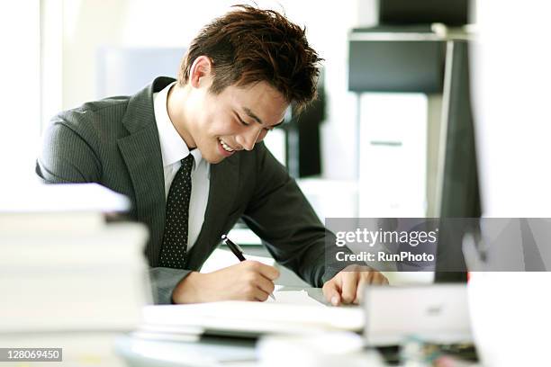 young businessmen working in the office - 会社員　日本人 ストックフォトと画像