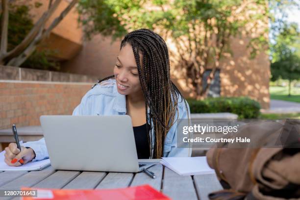 adult woman working outdoors at picnic table - university student picnic stock pictures, royalty-free photos & images