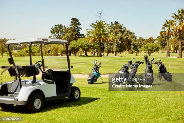 empty golf cart with golf bags on field - golf bag stock pictures, royalty-free photos & images