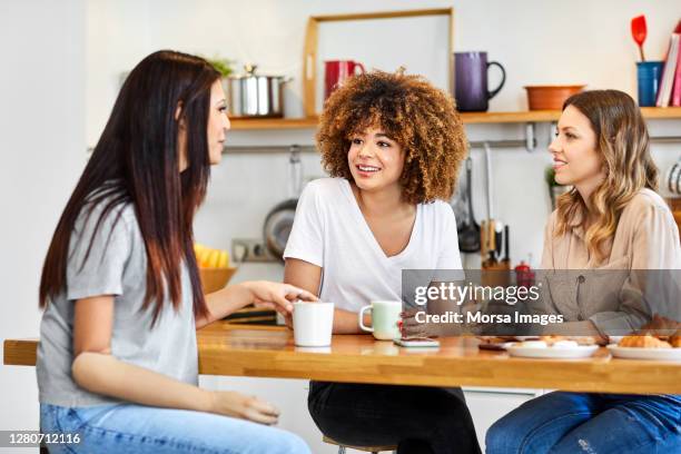 women having coffee at home during lockdown - amputee home stock pictures, royalty-free photos & images